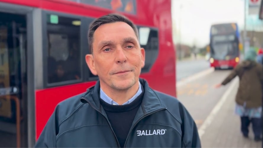 Ballard's Nicolas Pocard standing in front of public transit buses